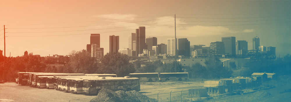 Skyline of Denver, Colorado, with a bus parking lot in the foreground